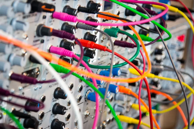 Colorful patch cables in a board with knobs