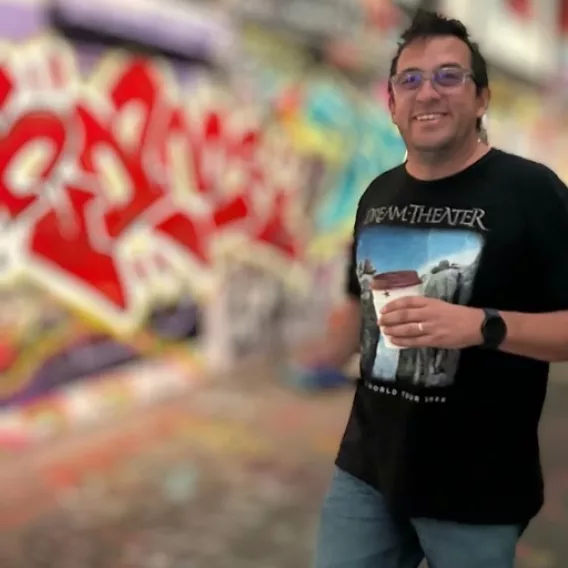 Carlos Ospina walking in London with a Coffee cup